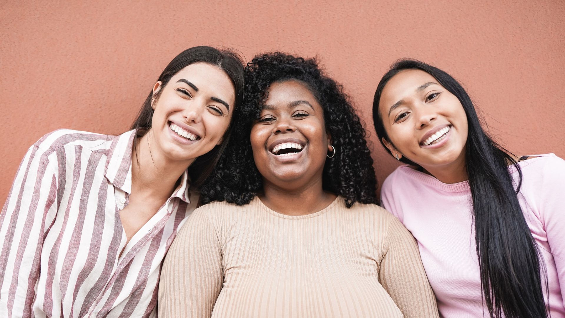 Three women laughing together